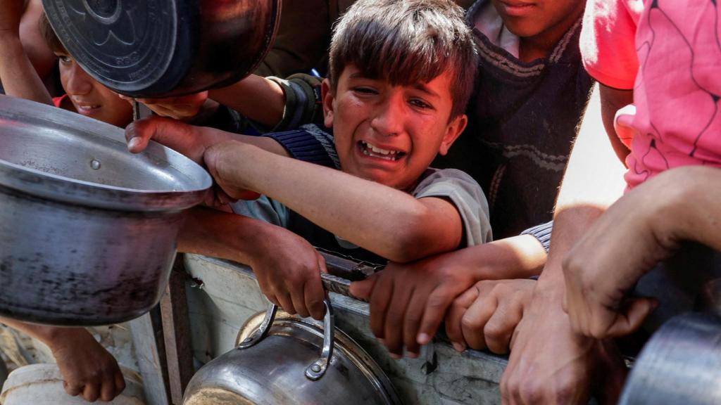 Un niño gazatí llora mientras espera una larga cola para recibir comida en Khan Younis.